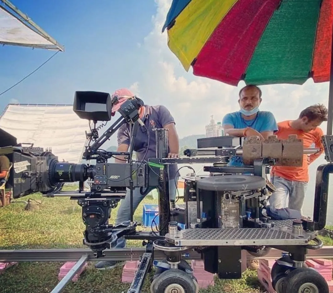 Cinema camera on a dolly track at an outdoor Redpoint shoot